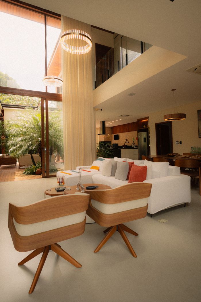 services-03 Spacious modern living room featuring luxurious furniture and abundant natural light through large windows.