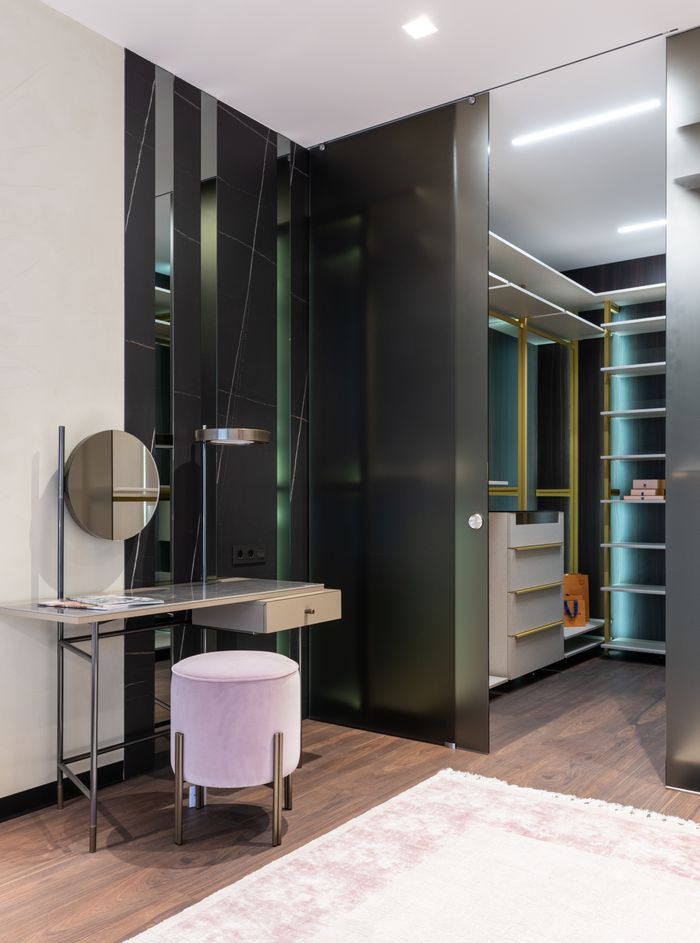 services-02 Interior of contemporary apartment with spacious dressing area and vanity table with mirror near padded stool